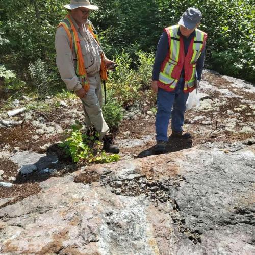 Local Geologists Examine Mineralized Porphyry Near Shaft